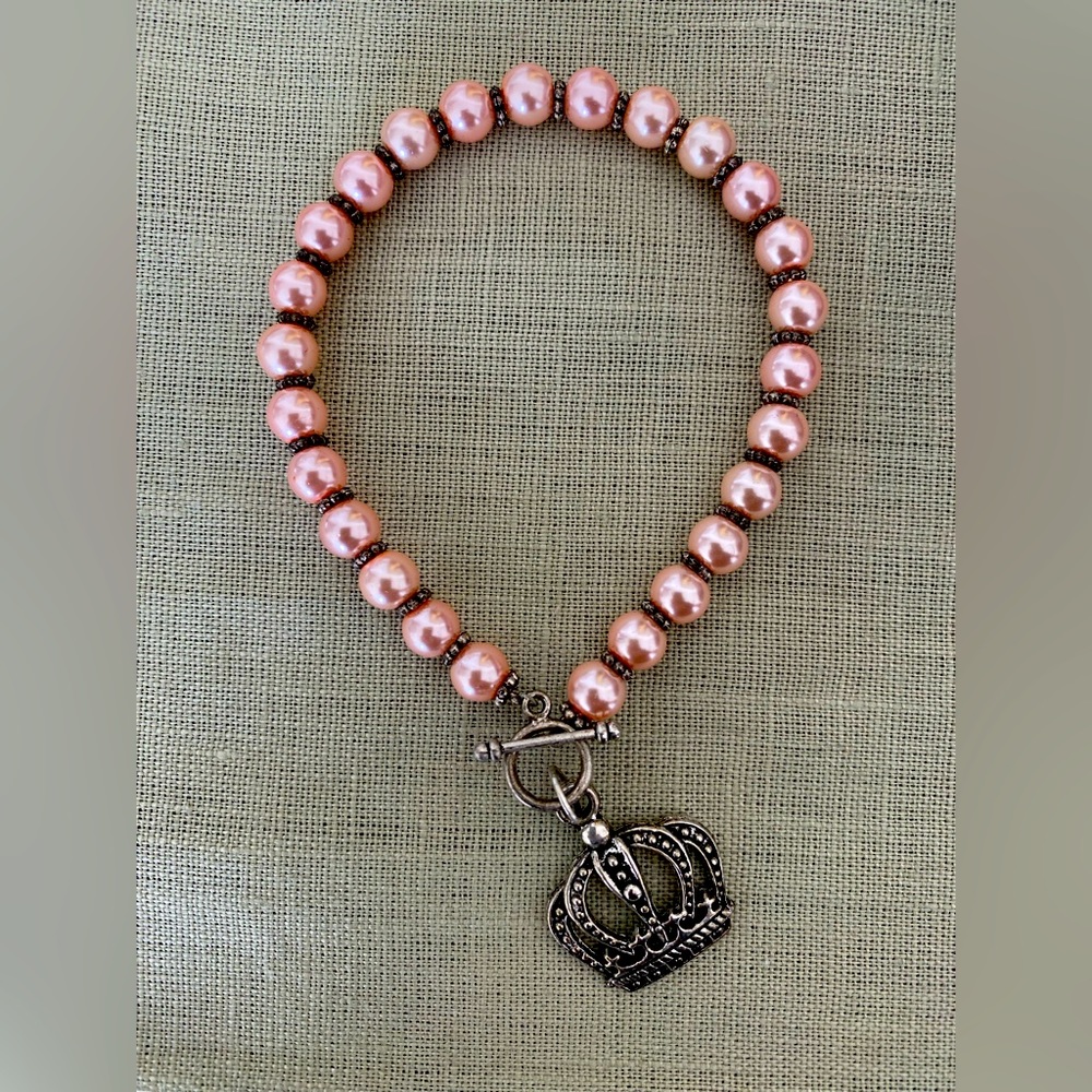 Pink beaded bracelet, crown charm